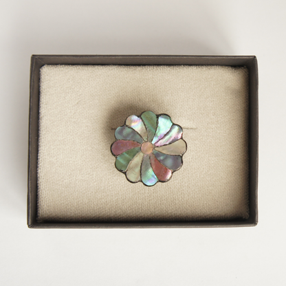 ‘Autumn Bloom', a raden obidome by Kaori Sugano. A contemporary reinterpretation of the traditional twisted chrysanthemum motif. A piece of cypress wood has been carved into the silhouette of a chrysanthemum flower, approximately 3 centimetres in diameter, with natural mother-of-pearl in varying shades arranged petal by petal. Each piece has been meticulously crafted using traditional lacquer techniques.